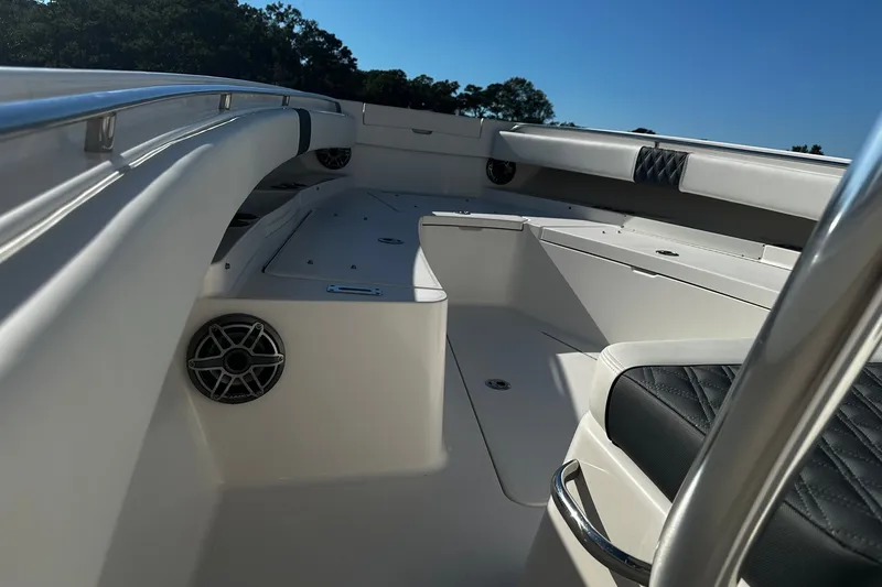 Slide: The Image of 2016 Regulator 28 Forward Seating boat interior with cushioned seats and speaker. - 19