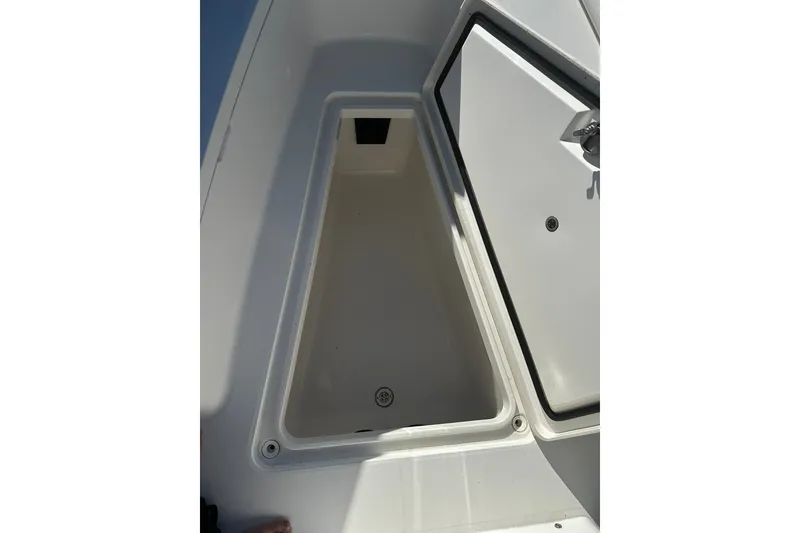 Slide: The Image of Open storage compartment on 2016 Regulator 28 Forward Seating boat. - 21