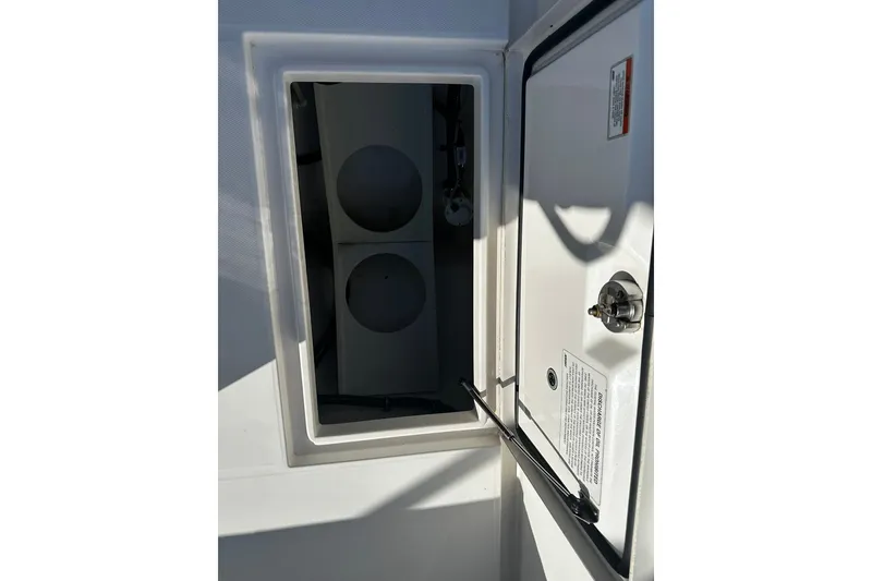 Slide: The Image of Open storage compartment on 2016 Regulator 28 Forward Seating boat. - 23