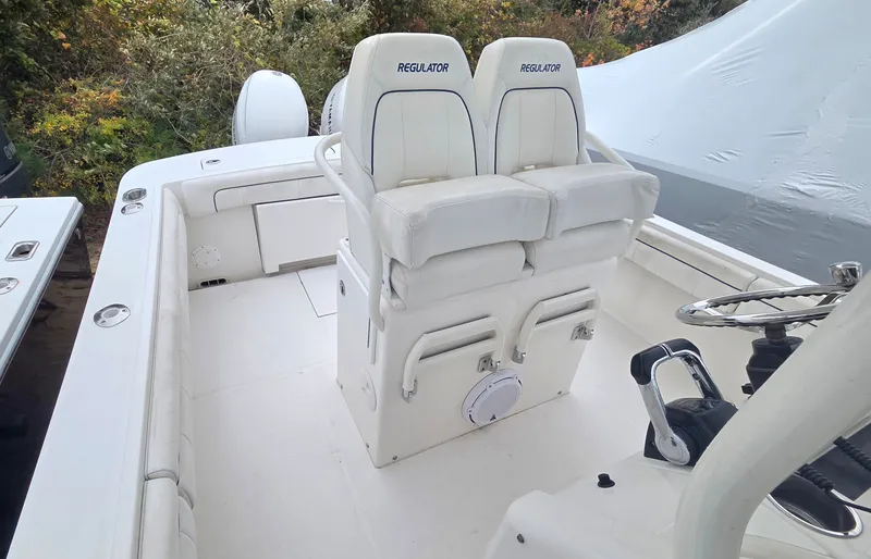 Slide: The Image of The image shows the cockpit of a 2016 Regulator FS boat with two white seats. - 8