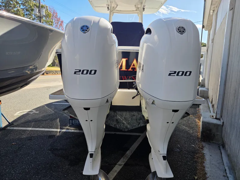 Slide: The Image of Two powerful outboard engines on a boat parked in a lot. - 3