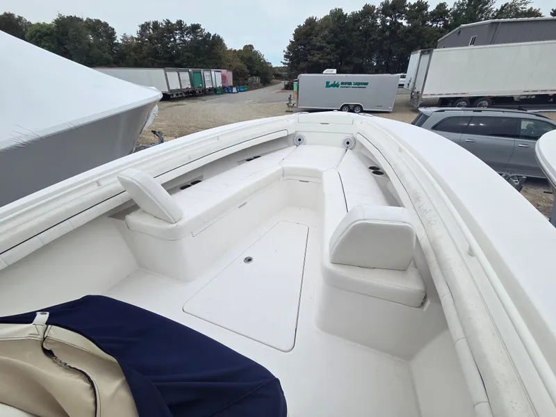 Slide: The Image of The boat features a spacious, white deck with seating, surrounded by trailers. - 7