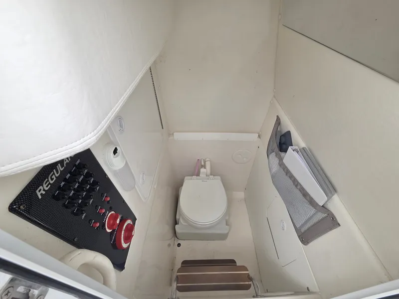 Slide: The Image of Compact bathroom with toilet and control panel inside a boat. - 6