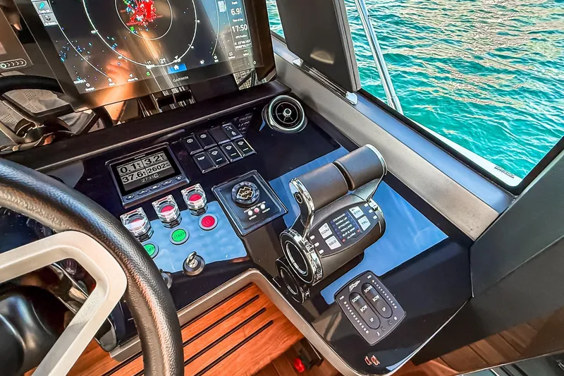 Slide: The Image of Helm of 2026 Princess S65 Sportbridge yacht with advanced navigation controls. - 97