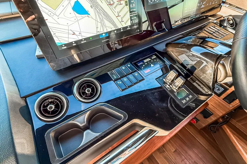 Slide: The Image of Control panel of 2026 Princess S65 Sportbridge yacht with navigation screens and controls. - 99