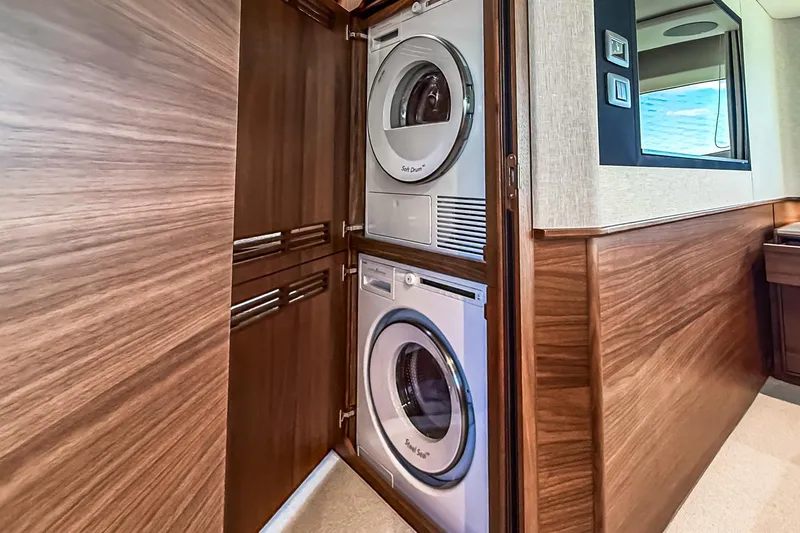Slide: The Image of Stacked washer and dryer in 2026 Princess S65 Sportbridge yacht interior. - 68