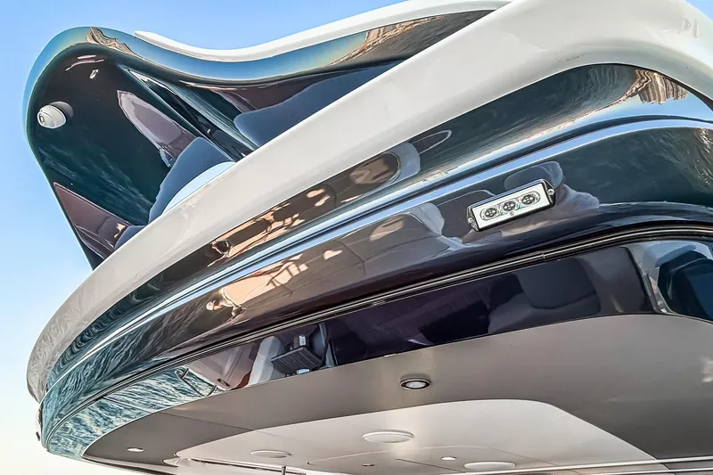 Slide: The Image of Close-up of 2026 Princess S65 Sportbridge yacht's sleek, modern design against a clear sky. - 73