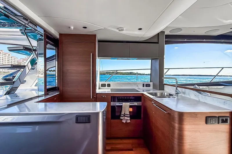 Slide: The Image of Luxurious 2026 Princess S65 Sportbridge yacht kitchen with ocean view and modern amenities. - 21