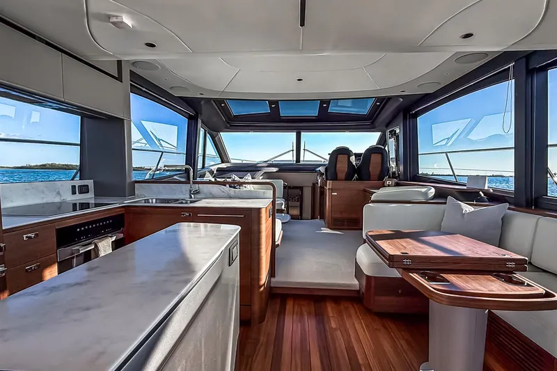 Slide: The Image of Luxurious interior of 2026 Princess S65 Sportbridge yacht with modern kitchen and seating area. - 19