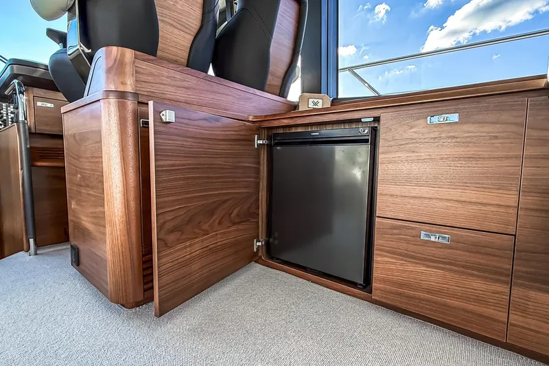 Slide: The Image of Luxurious wood interior of 2026 Princess S65 Sportbridge yacht with built-in mini fridge. - 40