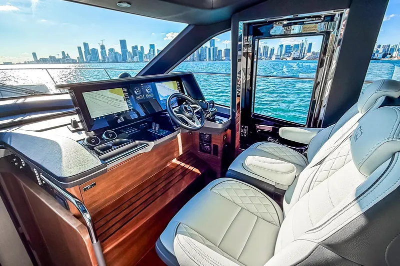 Slide: The Image of Luxurious 2026 Princess S65 Sportbridge yacht interior with modern dashboard and city skyline view. - 32