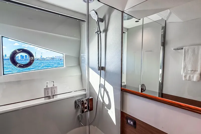 Slide: The Image of Luxurious bathroom on 2026 Princess S65 Sportbridge yacht with ocean view window. - 52