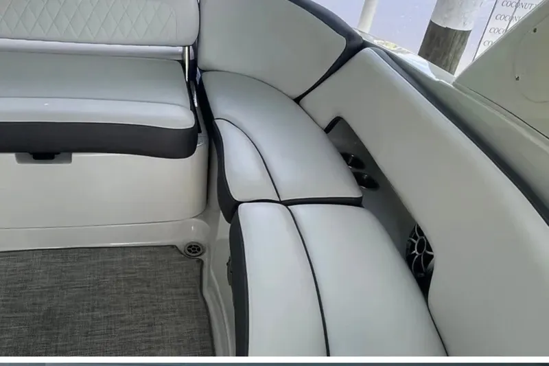Slide: The Image of 2022 Crownline 290 XSS boat interior with cushioned seating and modern design. - 7