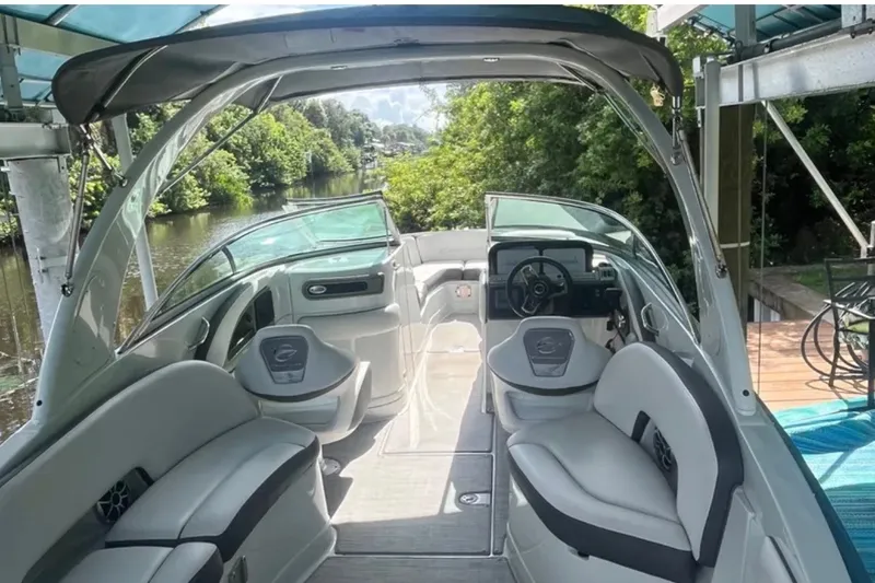 Slide: The Image of 2022 Crownline 290 XSS boat interior with sleek seating and modern dashboard. - 4