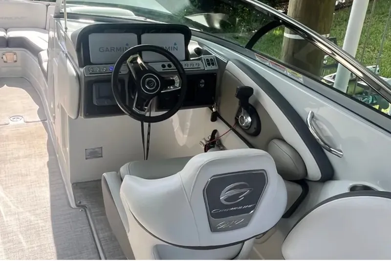 Slide: The Image of 2022 Crownline 290 XSS boat cockpit with steering wheel and Garmin displays. - 5