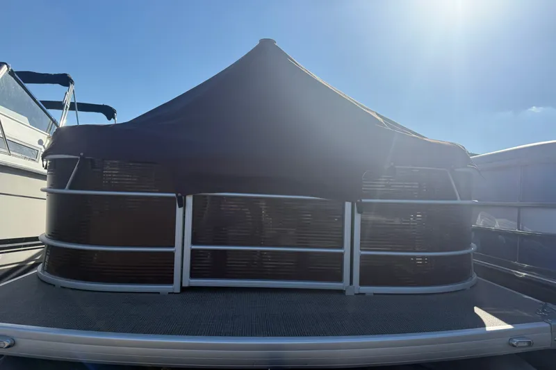 Slide: The Image of 2018 Sweetwater 22 pontoon boat with cover under bright sunlight. - 4