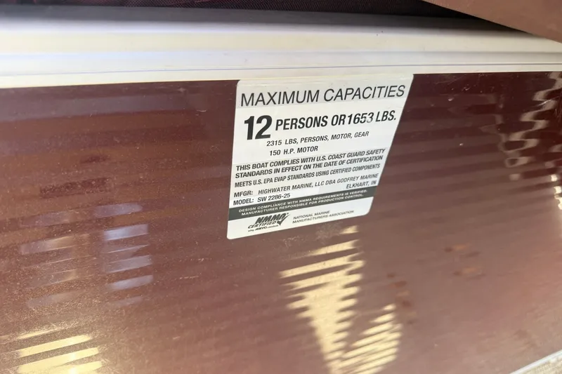 Slide: The Image of 2018 Sweetwater 22 boat capacity label, maximum 12 persons or 1653 lbs. - 12