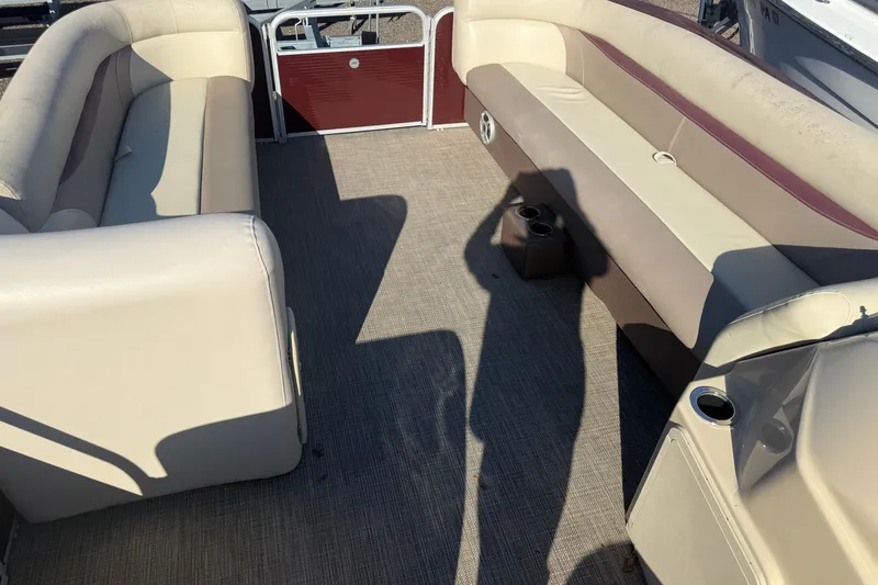 Slide: The Image of Interior of a 2018 Sweetwater 22 pontoon boat with beige seating and cup holders. - 6