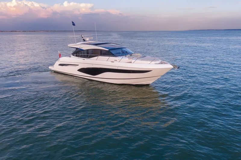 The Image of 2024 Princess V60 yacht cruising on open water at sunset. - 0
