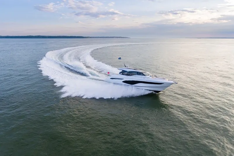 Slide: The Image of 2024 Princess V60 yacht cruising on open water, creating a dynamic wake. - 1