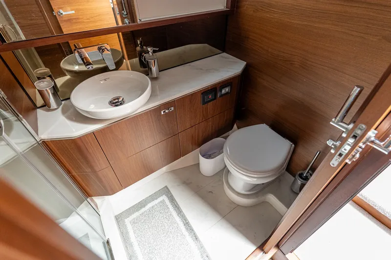 Slide: The Image of Luxurious bathroom in 2024 Princess V60 yacht with modern fixtures and wooden cabinetry. - 9