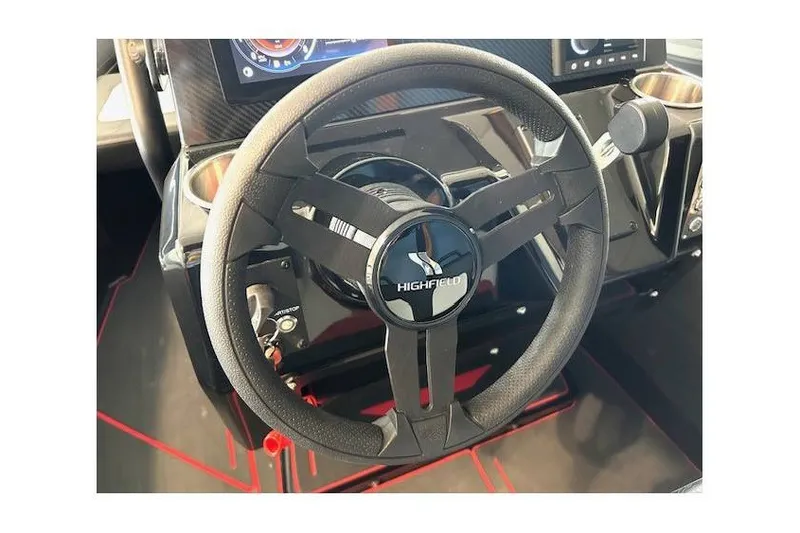 Slide: The Image of Steering wheel of 2026 Highfield Velox 560 boat, featuring modern dashboard controls. - 11