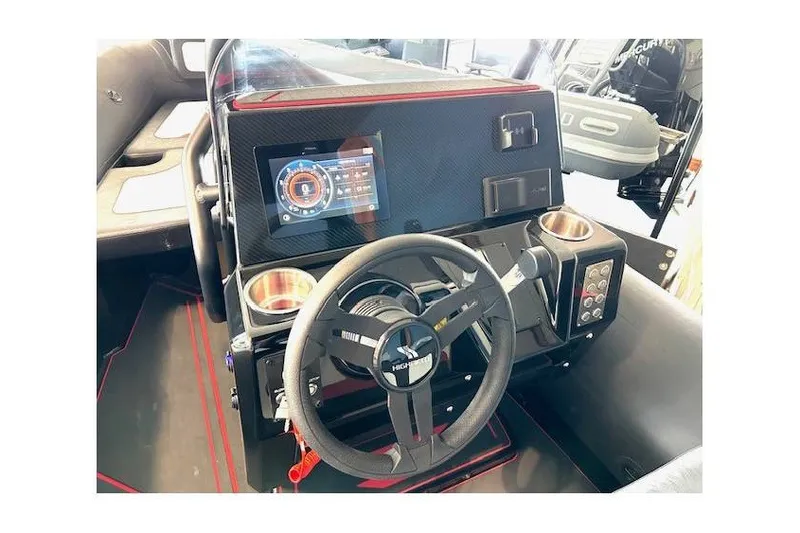Slide: The Image of Highfield Velox 560 boat dashboard with steering wheel and digital display, 2026 model. - 12