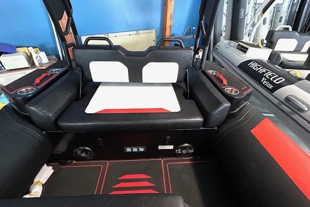 Slide: The Image of Interior of 2026 Highfield Velox 560 boat with modern seating and cup holders. - 6