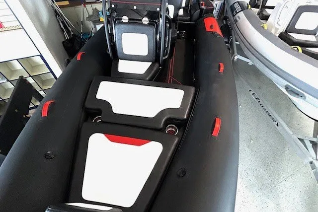Slide: The Image of 2026 Highfield Velox 560 inflatable boat interior with black and white seating. - 8