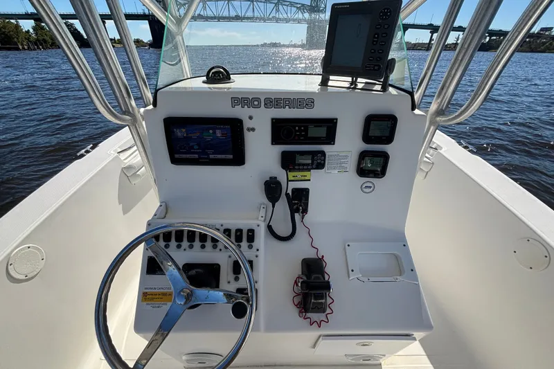 Slide: The Image of 2012 Sea Fox 256 Center Console boat dashboard with steering wheel and navigation equipment. - 7