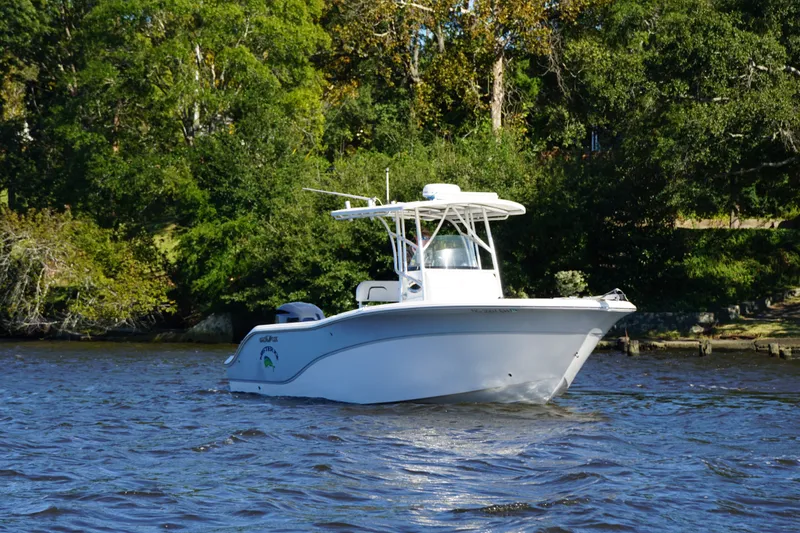 Slide: The Image of 2012 Sea Fox 256 Center Console boat on a scenic river with lush greenery. - 3