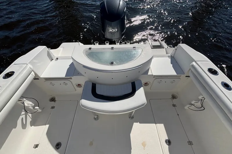 Slide: The Image of 2012 Sea Fox 256 Center Console boat interior with seating and engine view. - 10