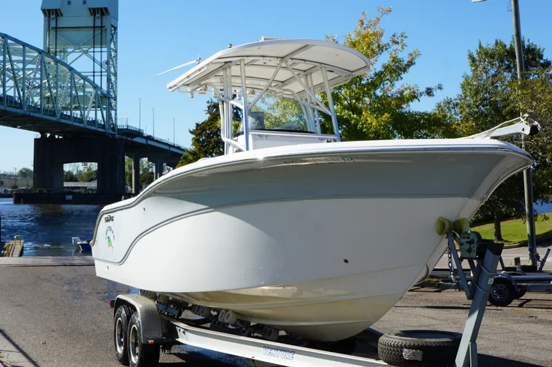 Slide: The Image of 2012 Sea Fox 256 Center Console boat on trailer near a bridge. - 6