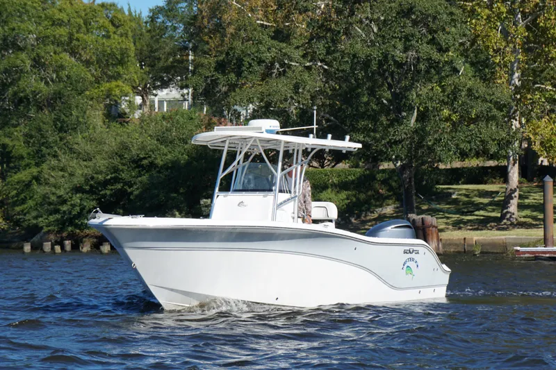 The Image of 2012 Sea Fox 256 Center Console boat cruising on a scenic river. - 1