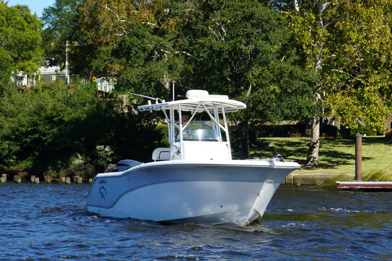 Slide: The Image of 2012 Sea Fox 256 Center Console boat cruising on a scenic river. - 14