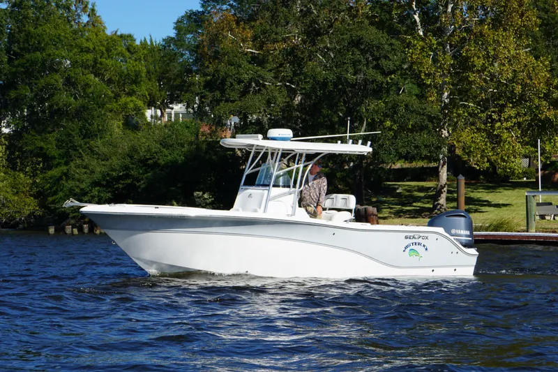 Slide: The Image of 2012 Sea Fox 256 Center Console boat cruising on a scenic river. - 15