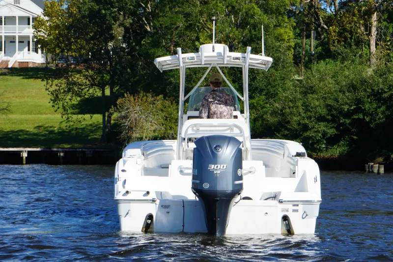 Slide: The Image of 2012 Sea Fox 256 Center Console boat cruising on a river near a grassy shoreline. - 5