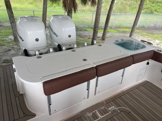 Slide: The Image of 2014 Everglades 325 Center Console boat with twin Mercury engines and cushioned seating. - 22