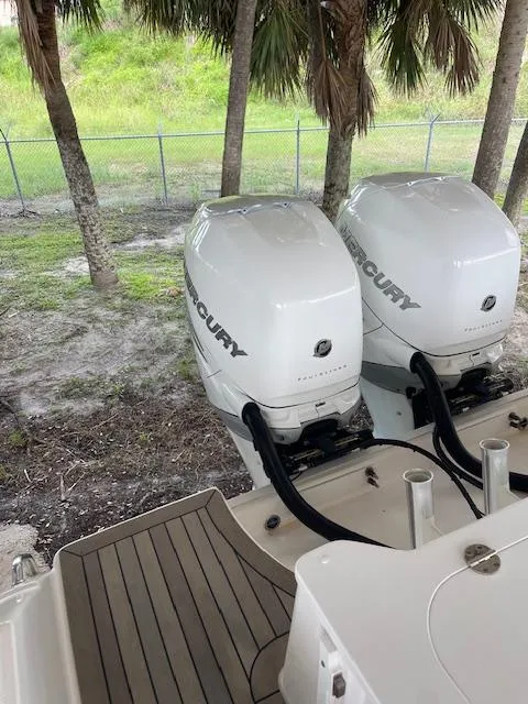 Slide: The Image of Twin Mercury outboard engines on a 2014 Everglades 325 Center Console boat. - 19