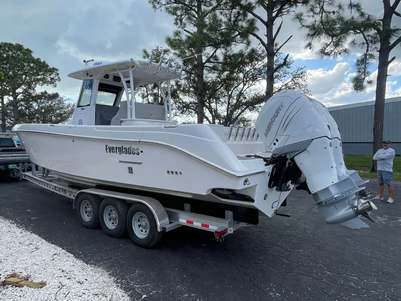 Slide: The Image of 2014 Everglades 325 Center Console boat on trailer, parked outdoors. - 6