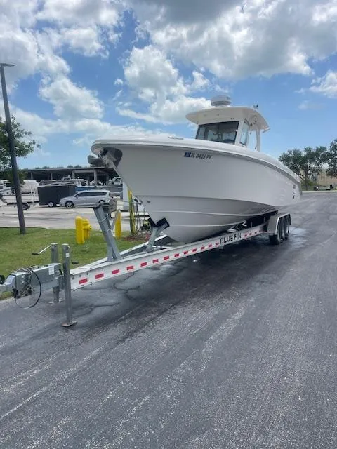 Slide: The Image of 2014 Everglades 325 Center Console boat on trailer under cloudy sky. - 20