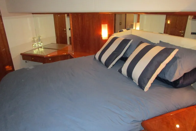 Slide: The Image of Luxurious bedroom interior of 2003 Neptunus 56 Flybridge yacht with striped pillows. - 19