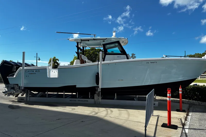 The Image of 2024 Caymas 401 CC boat on trailer under clear blue sky. - 0