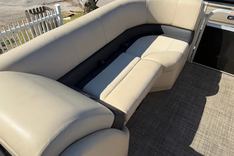 Slide: The Image of 2020 SunCatcher V322C boat interior with beige seating and carpeted floor. - 9