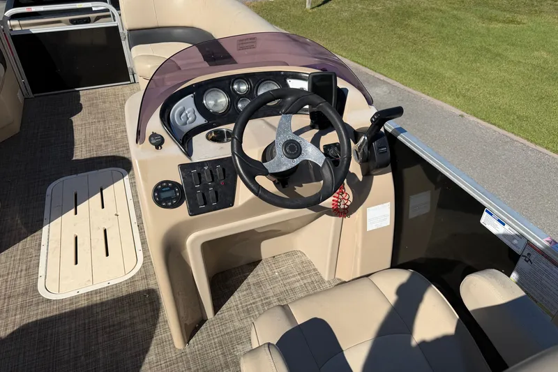 Slide: The Image of Cockpit of 2020 SunCatcher V322C pontoon boat with steering wheel and controls. - 13