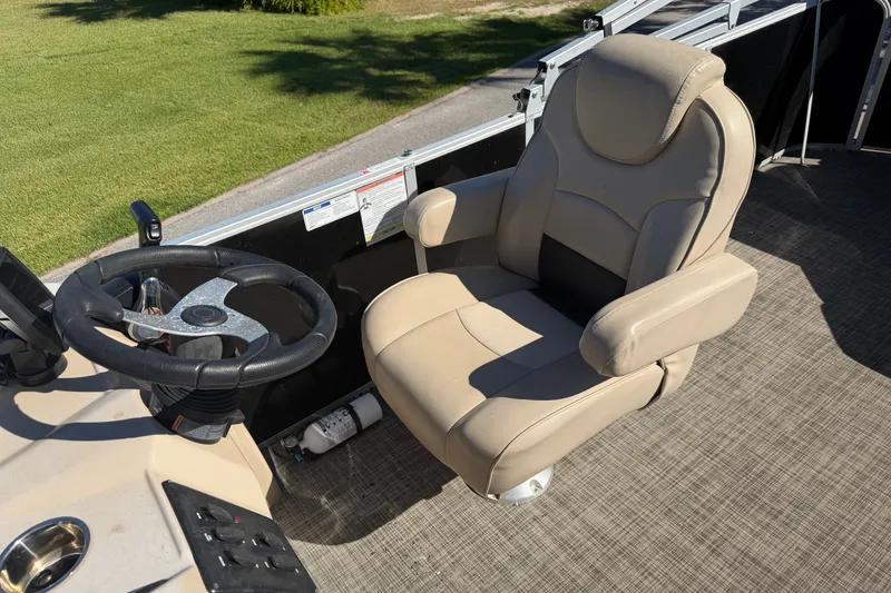Slide: The Image of Captain's chair and steering wheel on 2020 SunCatcher V322C boat, beige upholstery. - 12
