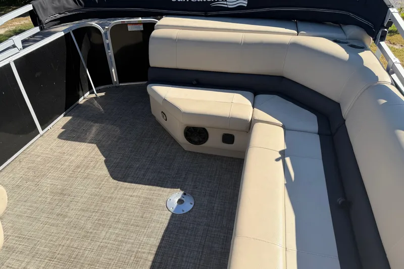 Slide: The Image of 2020 SunCatcher V322C pontoon boat interior with beige seating and carpeted floor. - 18