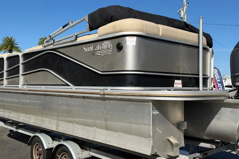 Slide: The Image of 2020 SunCatcher V322C pontoon boat on trailer, featuring sleek design and comfortable seating. - 3