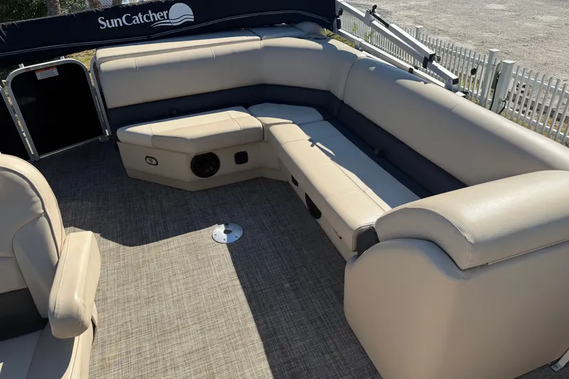 Slide: The Image of 2020 SunCatcher V322C pontoon boat interior with beige seating and carpeted floor. - 11