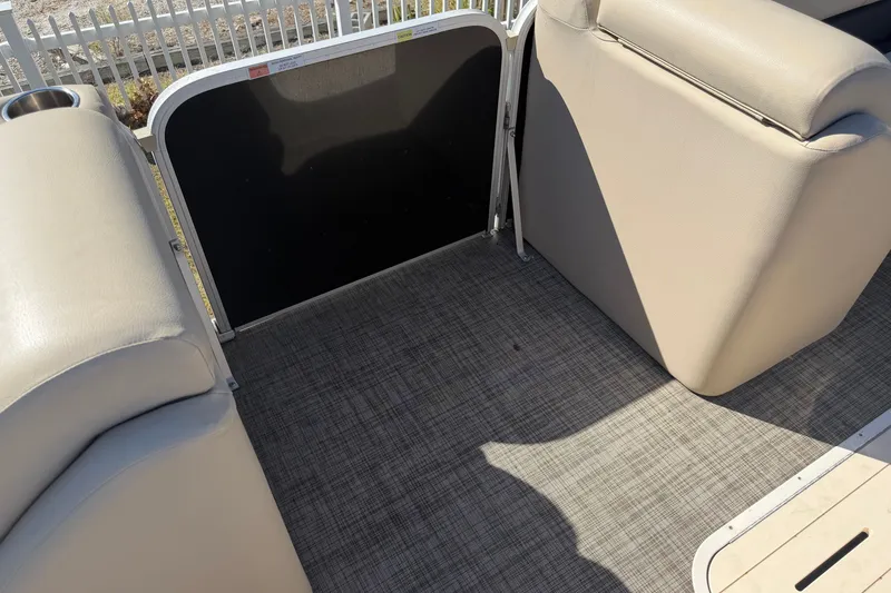 Slide: The Image of 2020 SunCatcher V322C boat interior with beige seating and textured flooring. - 23